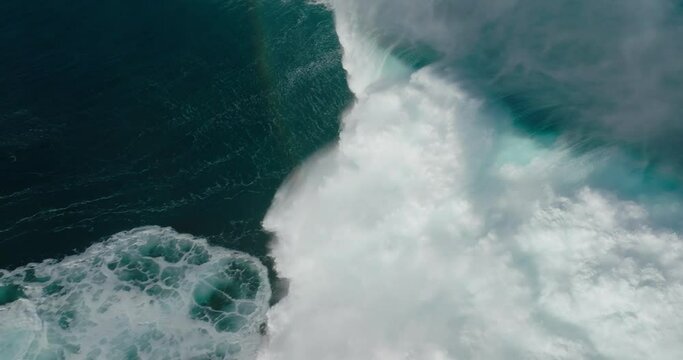 Top down view of giant ocean wave crashing