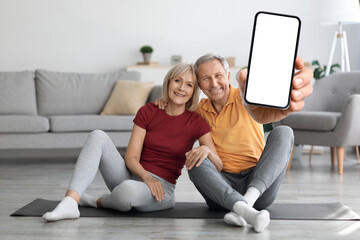 happy senior couple using fitness mobile application