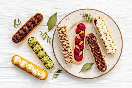 Eclairs with pistachio raspberries and chocolate cream topping