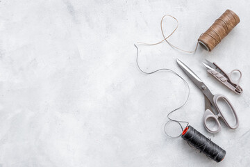 Tailoring scissors with bobbins of thread. Sewing background