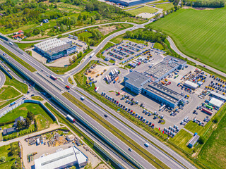 Aerial view of warehouse storages or industrial factory or logistics center from above. Top view of industrial buildings and trucks