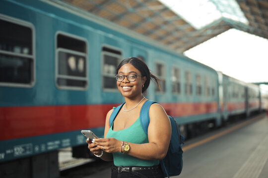 portrait of a young woman in a rail station