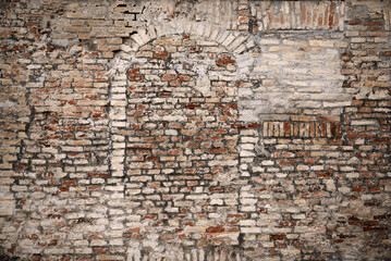 Old brick wall with blocked doorway as background