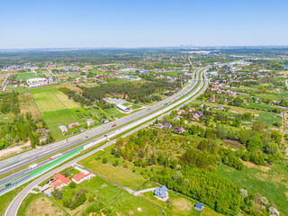 Aerial. Traffic on the intercity highway between the natural parkland. Top view from drone.