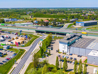 Aerial view of goods warehouse. Logistics center in industrial city zone from above. Aerial view of trucks loading at logistic center