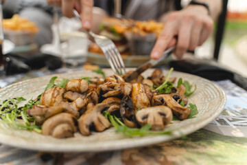 Close up of grilled mushrooms on a plate with greens
