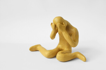 Plasticine figure of crying human on white background