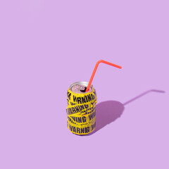Summer creative layout with soda can wrapped in warning packing tape  on pastel purple background....