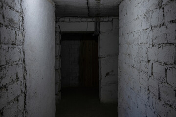Dark basement in an old residential of plastered bricks and concrete blocks