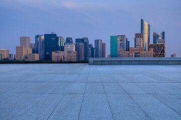 Empty square floor and city skyline with modern commercial buildings in Hangzhou, China.