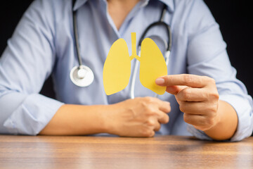 Doctor holding lungs symbol while sitting in the hospital