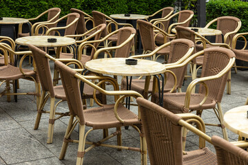 many wicker bar tables outside
