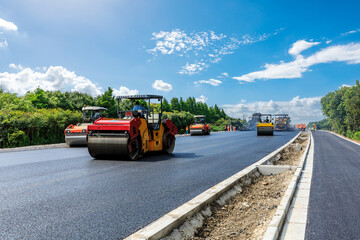 Construction site is laying new asphalt pavement, road construction workers and road construction...