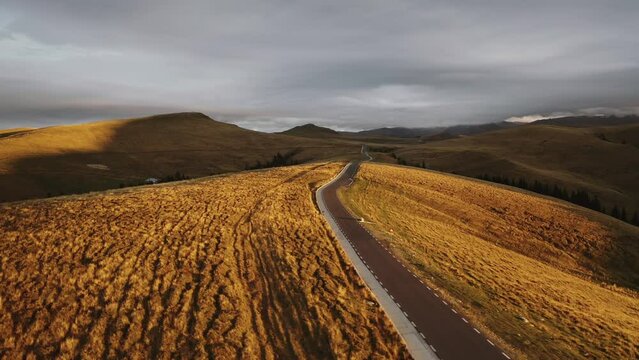 4K video with the amazing mountain road called Transbucegi, in Bucegi Mountains from Romania, during a dramatic autumn sunrise. Roads of Romania.
