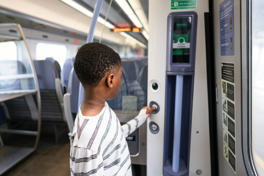 Boy bushing button on train