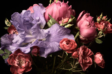 Wintage flowers, bouquet of peonies roses and iris on a black background, studio shot.