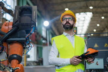 Automation engineer holding scanner in industrial in factory.