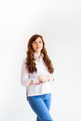 Young caucasian woman in casual clothes. The smile of a beautiful woman. Long curly red hair