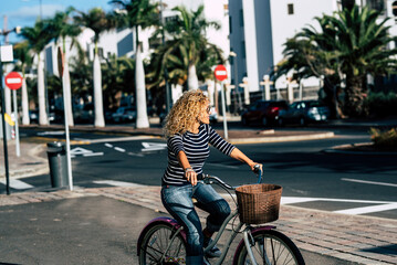 Young active adult woman use bike and take a ride in the town. People and outdoor leisure activity....