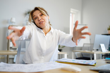 Busy woman boss talking on the phone and nervously waving her hands