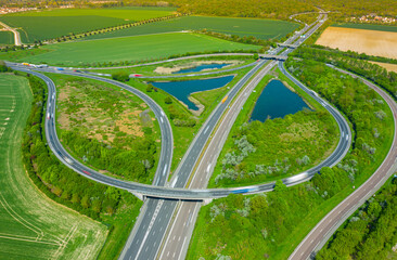 Overpass junction with a traffic circle, viaducts, slip roads, cars. Aerial drone photo of ring road.  a popular multilevel circular junction road