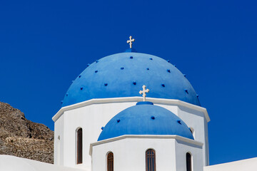 Classical orthodox white greek church with blue dome.