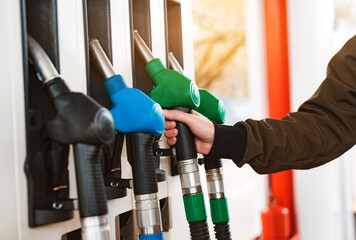 Unrecognizable man refueling car from gas station filling benzine gasoline fuel in car at gas...