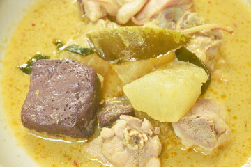 spicy boiled slice winter melon with chicken and blood in coconut milk green curry soup on plate