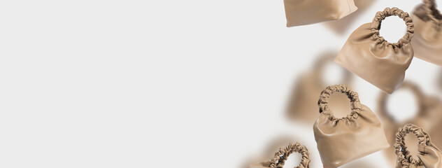 A set of brown bags made of eco-friendly leather. Banner of a floating handbags on a gray background. Composition of fashionable women's accessories. Handmade eco-friendly leather bag. Copy space