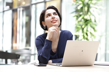Young businesswoman using laptop in office