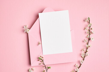 Invitation or greeting card mockup with white flowers on pink background