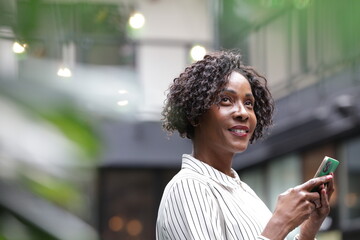 Smiling businesswoman using smart phone © Cultura Creative