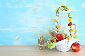 Photo of dairy products over wooden table. Symbols of jewish holiday - Shavuot