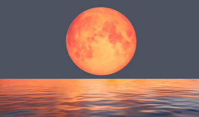 The Big bloody red moon  is reflected in the waves of the sea  