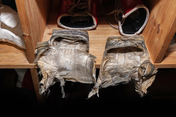 Inside of old, worn pair of boxing gloves, material distressed and  ripped apart