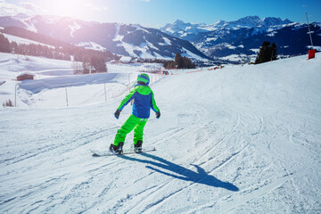 Fototapeta na wymiar Fast action photo of snowboarder boy go downhill on snowboard