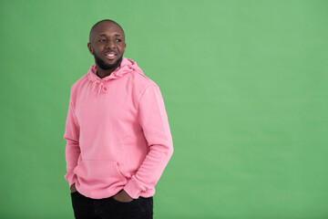 Studio portrait of mid adult man wearing pink sweatshirt