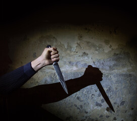 Shadow of the hand holding a big knife