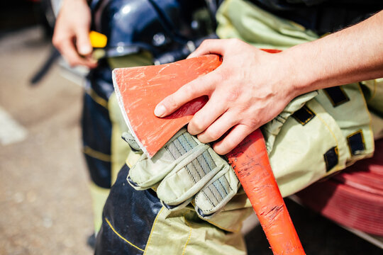 Ax on a Firefighters hands close-up