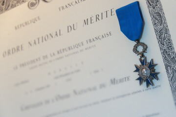 Fototapeta na wymiar French medal and anonymous certificate of the National Order of Merit