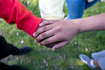 Friends stacking hands together