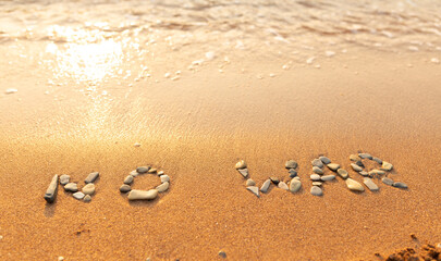 Words written in the sand on the beach. The words No War and written in the Sand with the Ocean in the background. Protest War sign written in sand. World Peace. No War