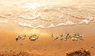 Words written in the sand on the beach. The words No War and written in the Sand with the Ocean in the background. Protest War sign written in sand. World Peace. No War