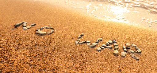 Words written in the sand on the beach. The words No War and written in the Sand with the Ocean in the background. Protest War sign written in sand. World Peace. No War