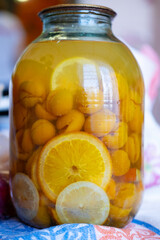 Homemade compote of apricots and oranges in a glass jar