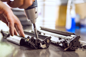 hands repairing laser toner cartridge - obrazy, fototapety, plakaty