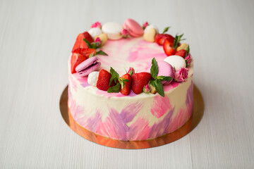 Obraz na płótnie Canvas Beautiful cake with strawberries and macaroons