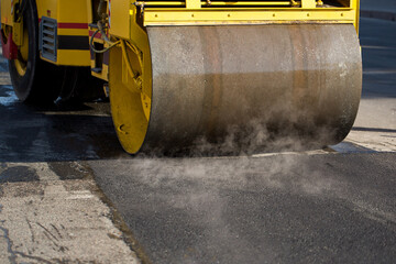 Road roller compacting asphalt