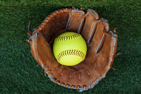 The softball ball in the softball glove has space for text.