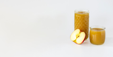 apple juice with pulp not filtered or clarified in a high glass and a slice of apple, space for text, banner
